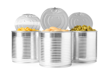 Open tin cans of peas, beans and corn kernels isolated on whiteの写真素材