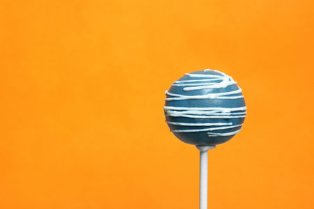 Bright delicious cake pop on color background. Space for textの写真素材
