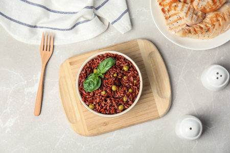 Flat lay composition with delicious cooked brown rice on white marble tableの写真素材