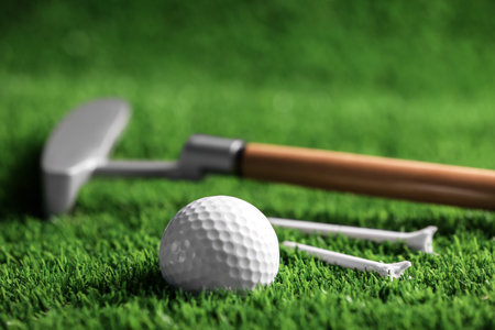 Set of golf equipment on green artificial grassの写真素材