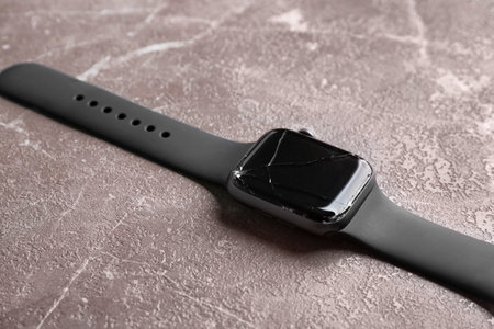 Broken smart watch on marble background, closeup. repair serviceの写真素材