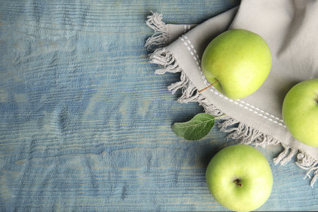 Flat lay composition of fresh ripe green apples on wooden table, space for textの写真素材