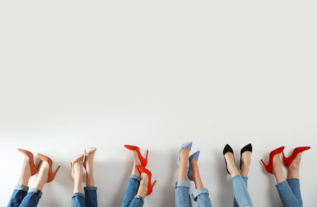 Young women in elegant shoes on white background, closeupの写真素材