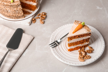 Sweet carrot cake with delicious cream on white marble tableの写真素材