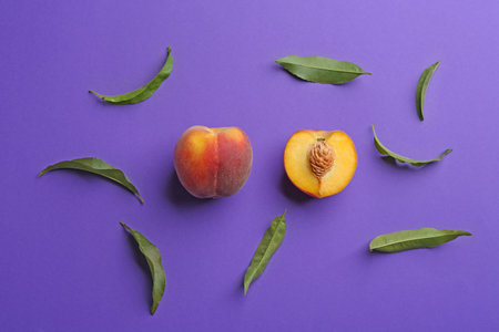 Flat lay composition with fresh peaches on purple backgroundの写真素材