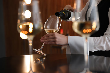 Waitress pouring wine into glass in restaurant, closeupの写真素材