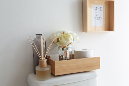 Decor elements, necessities and toilet bowl near white wall. bathroom interiorの写真素材