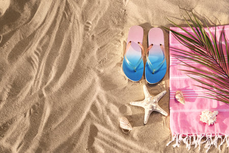 Flat lay composition with stylish beach accessories on sand. Space for textの写真素材