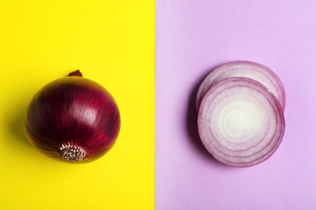 Cut and whole red onions on color background, flat layの写真素材