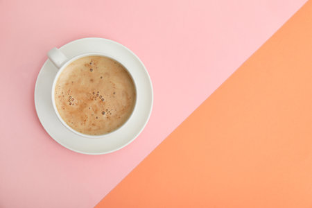 Cup of coffee on color background, top view. Space for textの写真素材