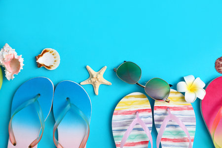 Flat lay composition with different flip flops on blue background, space for text. summer beach accessoriesの写真素材