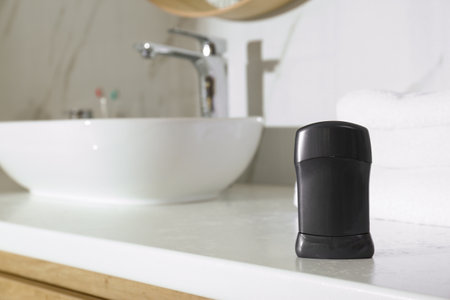 Deodorant container on light countertop in bathroomの写真素材