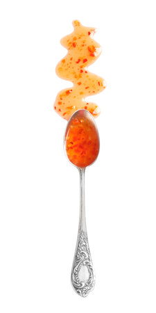 Delicious sweet chili sauce and spoon on white background, top viewの写真素材