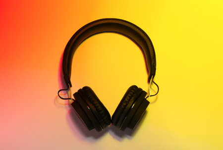 Stylish headphones on color background, top viewの写真素材