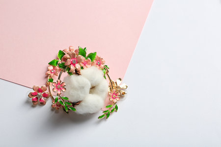 Stylish earrings and cotton flower on color background, space for text. Luxury jewelryの写真素材