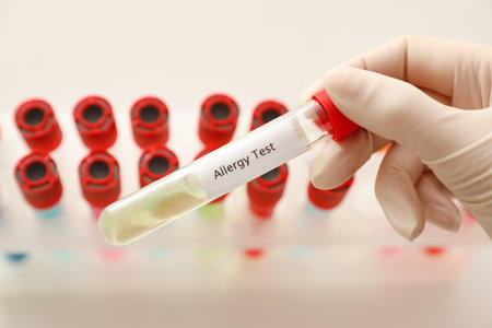 Doctor holding tube with label ALLERGY TEST over table, closeupの写真素材
