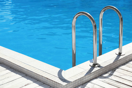 Modern swimming pool with step ladder outdoorsの写真素材