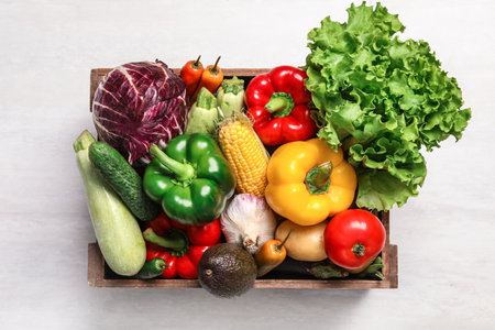 Crate with different fresh vegetables on light background, top viewの写真素材