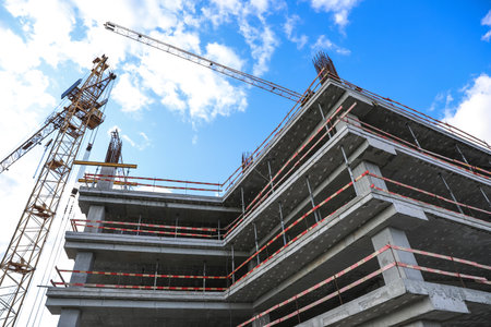 Unfinished building against blue sky. Construction safety rules