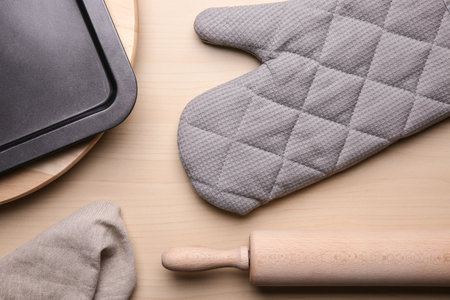 Flat lay composition with oven glove and kitchenware on wooden tableの写真素材