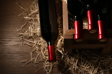 Composition with crate and bottles of wine on wooden tableの写真素材