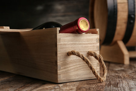 Crate with bottle of wine on wooden tableの写真素材
