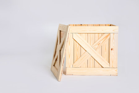 Open wooden crate on gray background. Space for textの写真素材