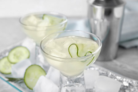 Glass of tasty cucumber martini on table, closeupの写真素材