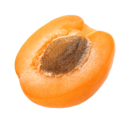 Half of delicious ripe apricot with stone isolated on whiteの写真素材