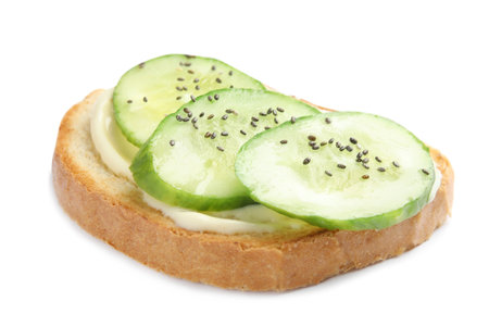 Slice of bread with spread and cucumber on white backgroundの写真素材