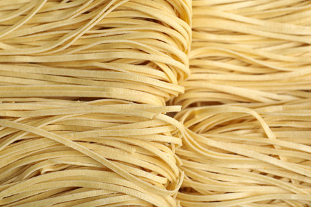 Tasty raw egg noodles as background, top viewの写真素材