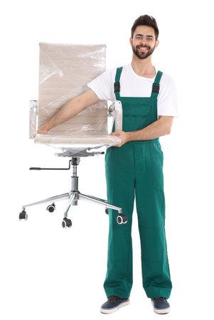 Young worker carrying office chair isolated on white. Moving serviceの写真素材