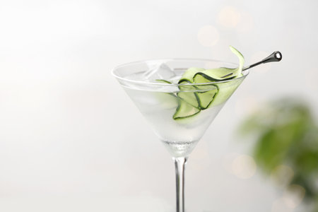 Glass of tasty cucumber martini against light background, closeupの写真素材