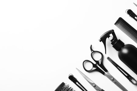 Composition with scissors and other hairdresser's accessories on white background, top viewの写真素材