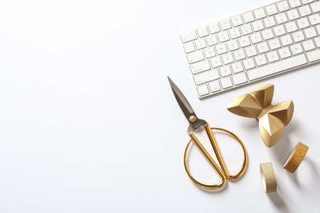 Composition with scissors, keyboard and gold butterfly on white background, top viewの写真素材