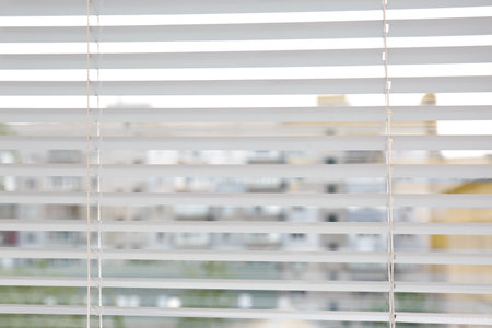 Window with open modern horizontal blinds indoors, closeup