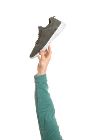 Man holding stylish shoe on white background, closeup