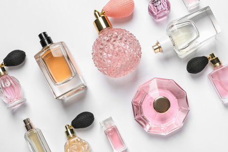 Different luxury perfume bottles on white background, top viewの写真素材