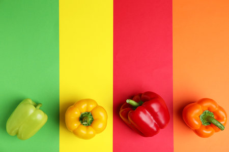 Flat lay composition with ripe bell peppers on color backgroundの写真素材