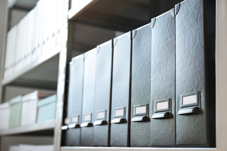 Folders with documents on shelf in archive