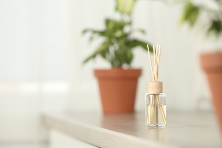 Reed air freshener on table indoors, space for textの写真素材