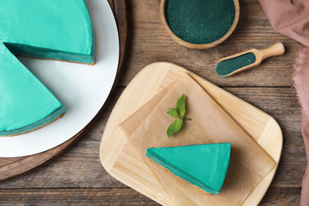 Delicious homemade spirulina cheesecake served on wooden table, top viewの写真素材