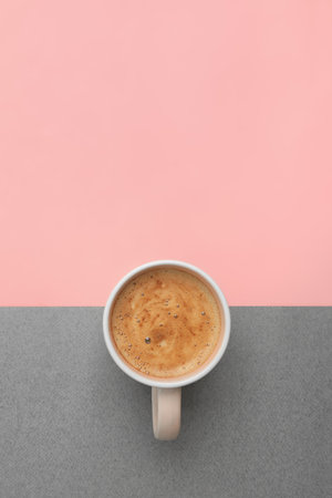 Cup of coffee on color background, top view. Space for textの写真素材