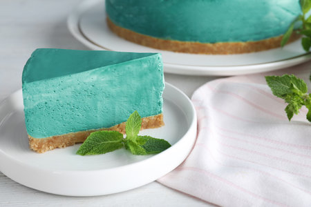 Delicious homemade spirulina cheesecake served on white wooden tableの写真素材
