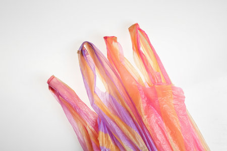 Color plastic bags isolated on white, top view