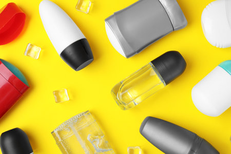 Flat lay composition with different male deodorants on yellow backgroundの写真素材