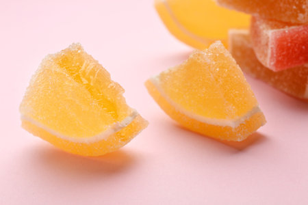 Tasty fresh jelly candies on color background