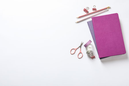 Composition with scissors and stationery on white background, top viewの写真素材