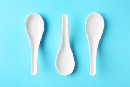 Miso soup spoons on blue background, flat layの写真素材