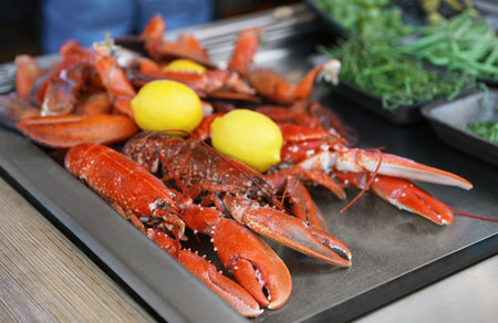 Delicious boiled crayfishes with lemons on tableの写真素材